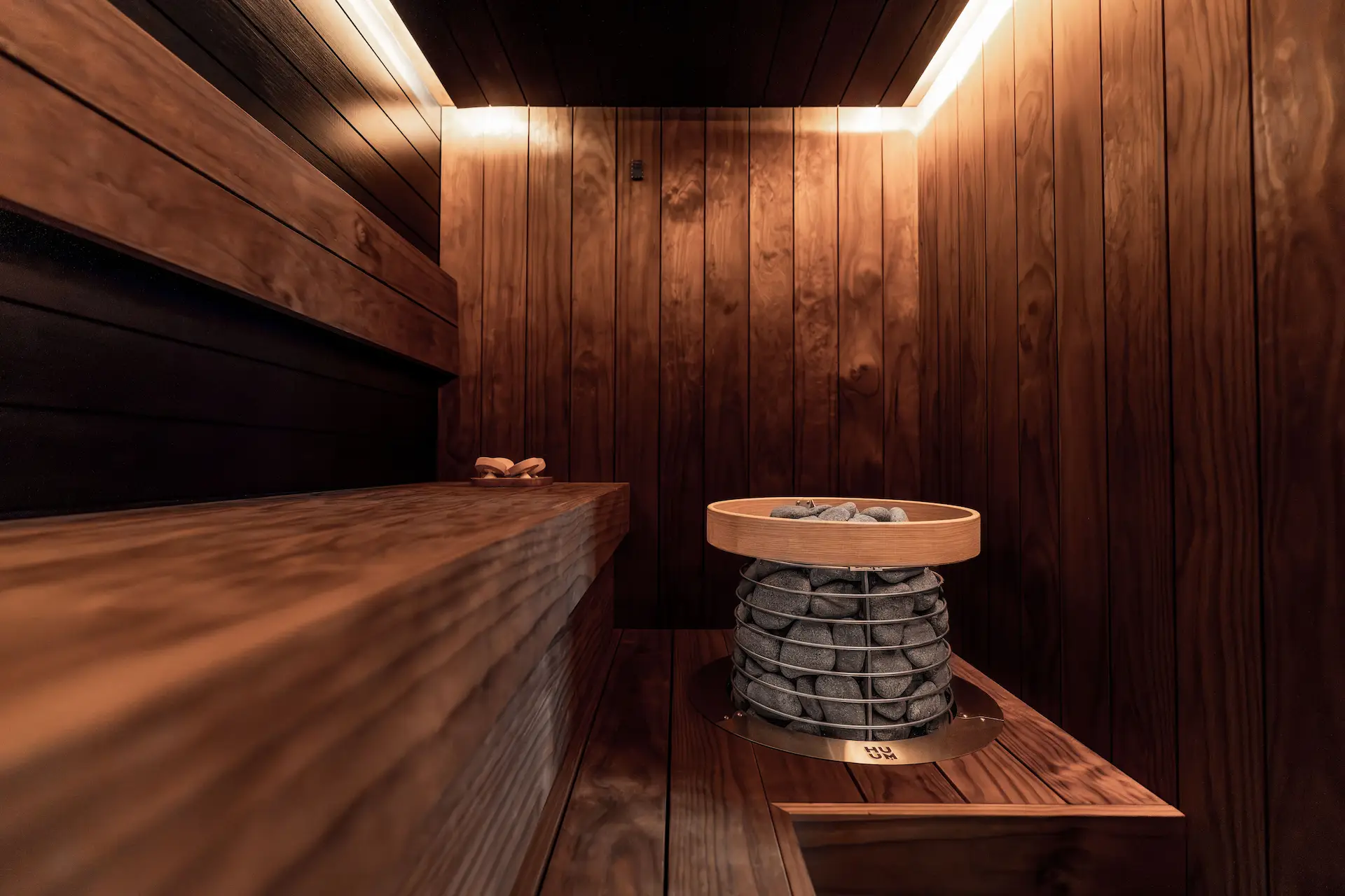 Person relaxing in a steaming cedar sauna at Sauna Club Co